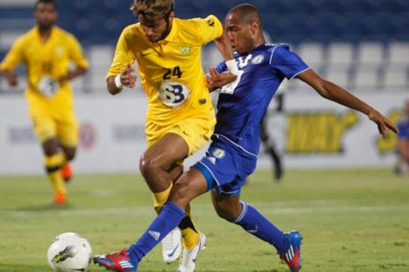 Rashed Saed (L) of the UAE's Al Wasl fights for the ball with Mohamad Al Alawi of Qatar's Al Khor during their GCC Champions League soccer match in Doha May 30, 2012. REUTERS/Mohammed Dabbous(QATAR - Tags: SPORT SOCCER)
