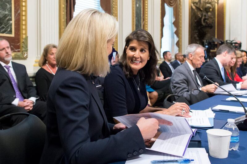 epa07086908 US Ambassador to the United Nations Nikki Haley (C) and US Secretary of Homeland Security Kirstjen Nielsen (L) attend the annual meeting of the Interagency Task Force to Monitor and Combat Trafficking in Persons, in the Indian Treaty Room in the Eisenhower Executive Office Building (EEOB) on the White House complex, in Washington, DC, USA, 11 October 2018.  EPA/MICHAEL REYNOLDS