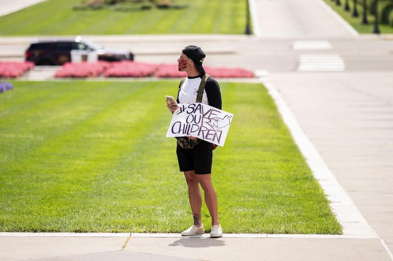 People gather during a "Save the Children" rally, inspired by the QAnon movement, outside the Capitol building on August 22, 2020 in St Paul, Minnesota. AFP