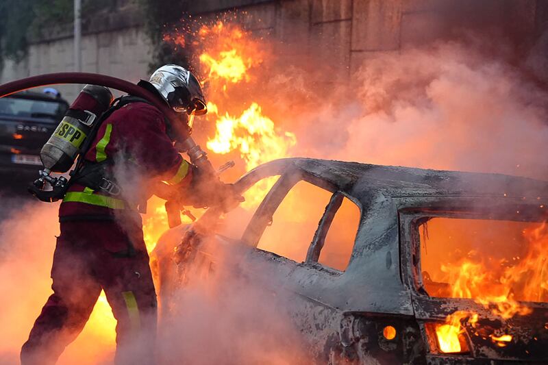 A car burns during a demonstration in Nanterre. AFP