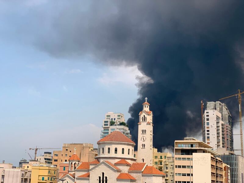 Thick black columns of smoke rise into the sky, in Beirut. AFP