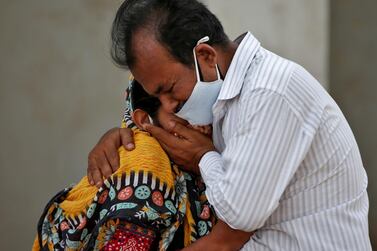 A woman is consoled by her relative outside a hospital in Ahmedabad, India, after her husband died from Covid-19 during the second wave. Reuters