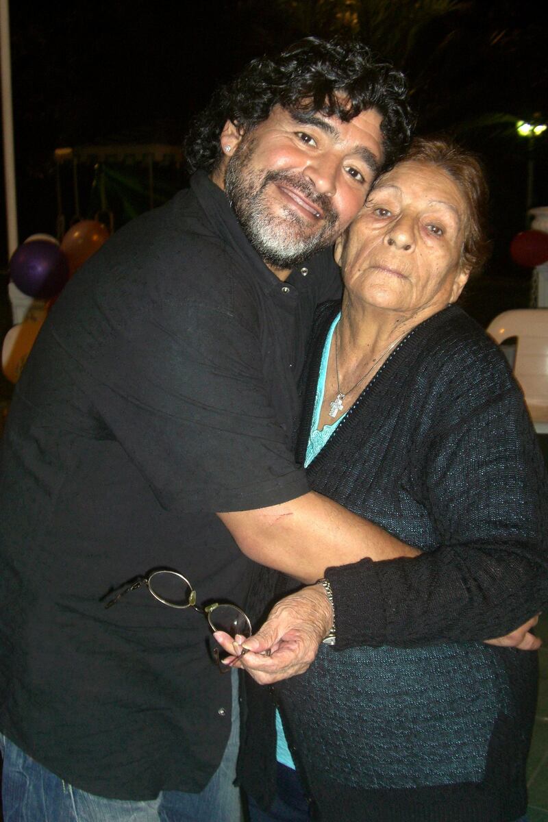 Handout picture given by Maradona's family showing Argentine former soccer star and coach of United Arab Emirates club Al-Wasl, Diego Maradona with his mother Dalma on September 2011 in Buenos Aires, in what it is supposed to be the last picture with her son Diego, according with Maradona's family.  Dalma Franco de Maradona, known to Argentines as Dona Tota, died late Saturday in a Buenos Aires clinic where was being treated for a heart condition. AFP PHOTO/MARADONA FAMILY/HO                               RESTRICTED TO EDITORIAL USE-NO MARKETING NO ADVERTISING CAMPAIGNS-MANDATORY CREDIT AFP PHOTO/MARADONA FAMILY/HO  -DISTRIBUTED AS A SERVICE TO CLIENTS (Photo by HO / AFP)