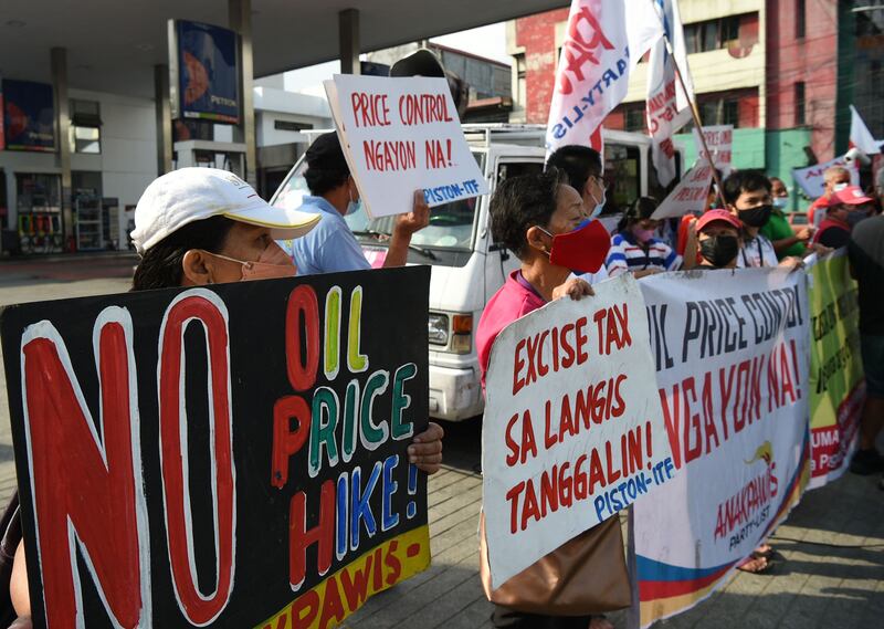Demonstrators protest against successive oil price increase in recent weeks, in front of a petrol station in Philippines' capital Manila. AFP