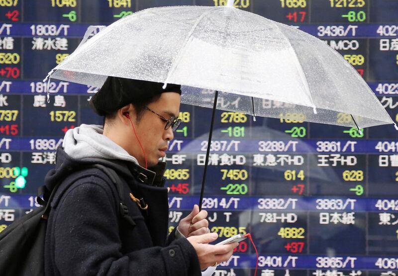 A man walks by an electronic stock board of a securities firm in Tokyo, Wednesday, Feb. 6, 2019. Shares have advanced in Asia following a rally on Wall Street led by technology companies. Japanâ€™s Nikkei 225 index gained 0.4 percent early Wednesday and Australiaâ€™s S&P ASX 200 climbed 0.4 percent. (AP Photo/Koji Sasahara)