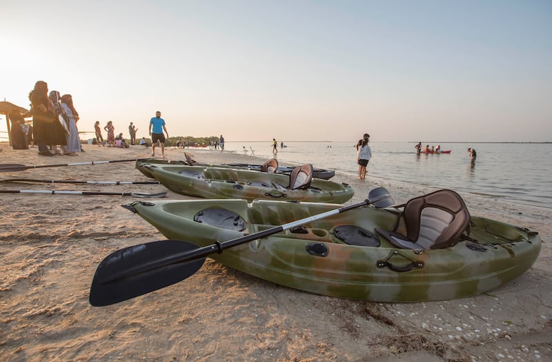 Kayaks lined up on the beach at the funky beachside hangout on the UAE's west coast