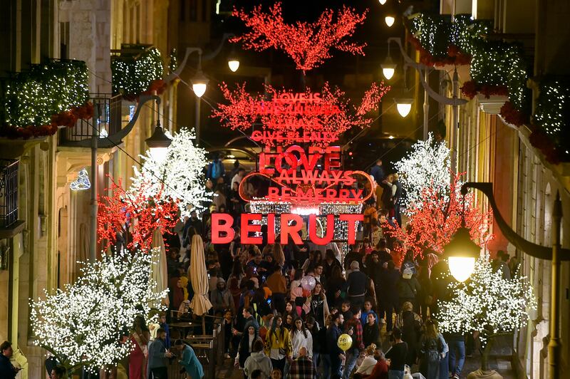 Shoppers throng beneath the festive illuminations at Beirut Souks. EPA