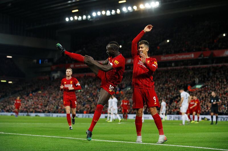 Liverpool striker Sadio Mane, left, celebrates after scoring his side's second goal against Sheffield United on Thursday, January 2. The 2-0 win meant Liverpool completed a full calendar year with a Premier League defeat. Reuters