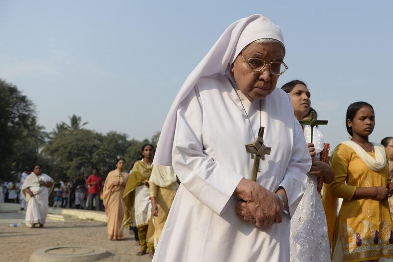 An Indian Catholic nun carries a palm cross during a Passion play at The Saint Joseph's church in Hyderabad. Noah Seelam / AFP Photo