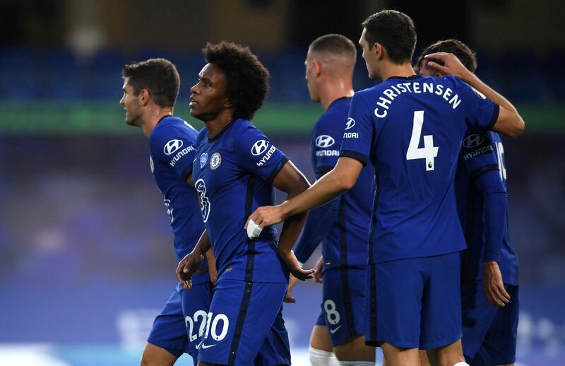 Willian celebrates scoring the second goal with teammates. Reuters