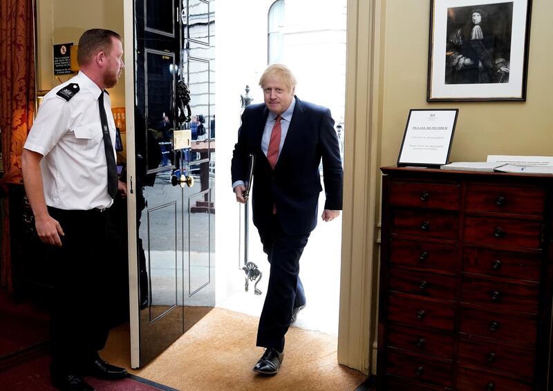A handout image released by 10 Downing Street, shows Britain's Prime Minister Boris Johnson returning to 10 Downing Street in central London on April 27, 2020 after making a statement to the media on his first day back at work following more than three weeks off after being hospitalised with the COVID-19 illness. - Prime Minister Boris Johnson on Monday made his first public appearance since being hospitalised with coronavirus three weeks ago, saying Britain was beginning to "turn the tide" on the outbreak but rejecting growing calls to ease a nationwide lockdown. (Photo by Andrew PARSONS / 10 Downing Street / AFP) / RESTRICTED TO EDITORIAL USE - MANDATORY CREDIT "AFP PHOTO / 10 DOWNING STREET / ANDREW PARSONS " - NO MARKETING - NO ADVERTISING CAMPAIGNS - DISTRIBUTED AS A SERVICE TO CLIENTS