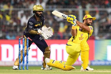 Chennai Super Kings' Suresh Raina plays a shot as Kolkata Knight Riders captain Dinesh Karthik watches during the 2019 IPL. AFP