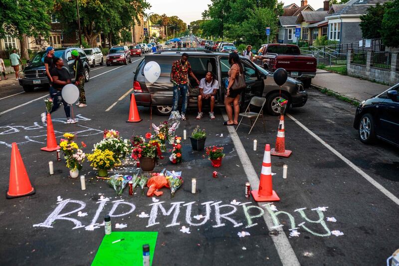 Friends of "Murphy", a man who died of gunshot wound during the Juneteenth celebration near the site of George Floyd's death, are mourning by a makeshirt memorial in Minneapolis, Minnesota.   AFP