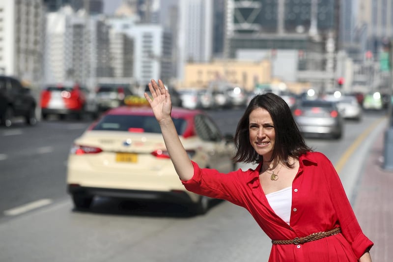 Dubai, United Arab Emirates - October 31, 2019: Yasmine Ghoneim trying to get taxi at side of the road. How its becoming more difficult to hail a taxi since launch of new app with Careem. Thursday the 31st of October 2019. Business Bay, Dubai. Chris Whiteoak / The National
