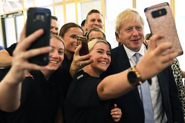 Boris Johnson poses for selfies with supporters during the Conservative leadership race earlier this month. Dylan Martinez / Pool via Bloomberg