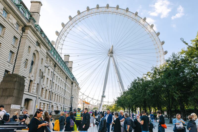 The long queue winds it's way past the London Eye. Bloomberg
