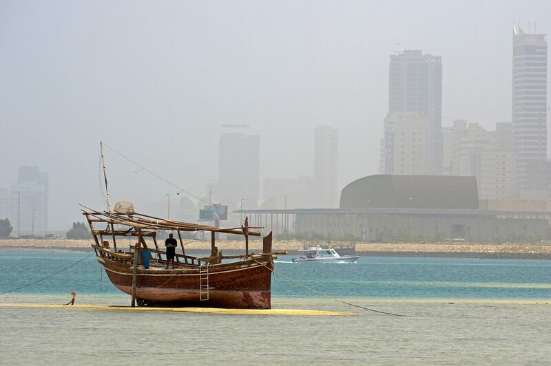 A picture taken from Muharraq Island shows a sandstorm engulfing the skyline of Bahrain's capital Manama. The Middle East's sandstorms are becoming more frequent and intense, a trend associated with overgrazing and deforestation, overuse of river water and more dams.  AFP