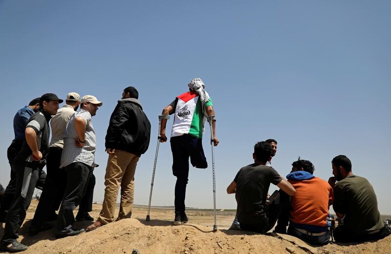 A Palestinian demonstrator with an amputated leg takes part in a protest marking the 71st anniversary of the 'Nakba', when hundreds of thousands fled or were forced from their homes in the war surrounding Israel's independence in 1948, near the Israel-Gaza border fence, east of Gaza City.  Reuters