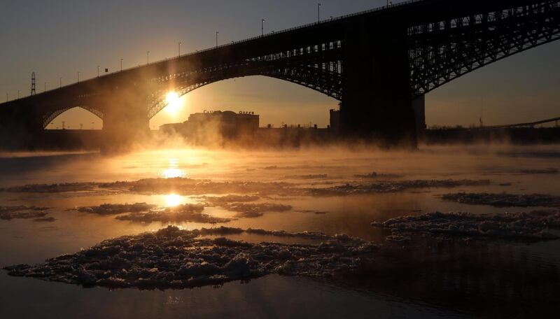 Mist rises above the waters of the Mississippi River underneath the Eads Bridge in St. Louis. Laurie Skrivan / St Louis Post-Dispatch via AP