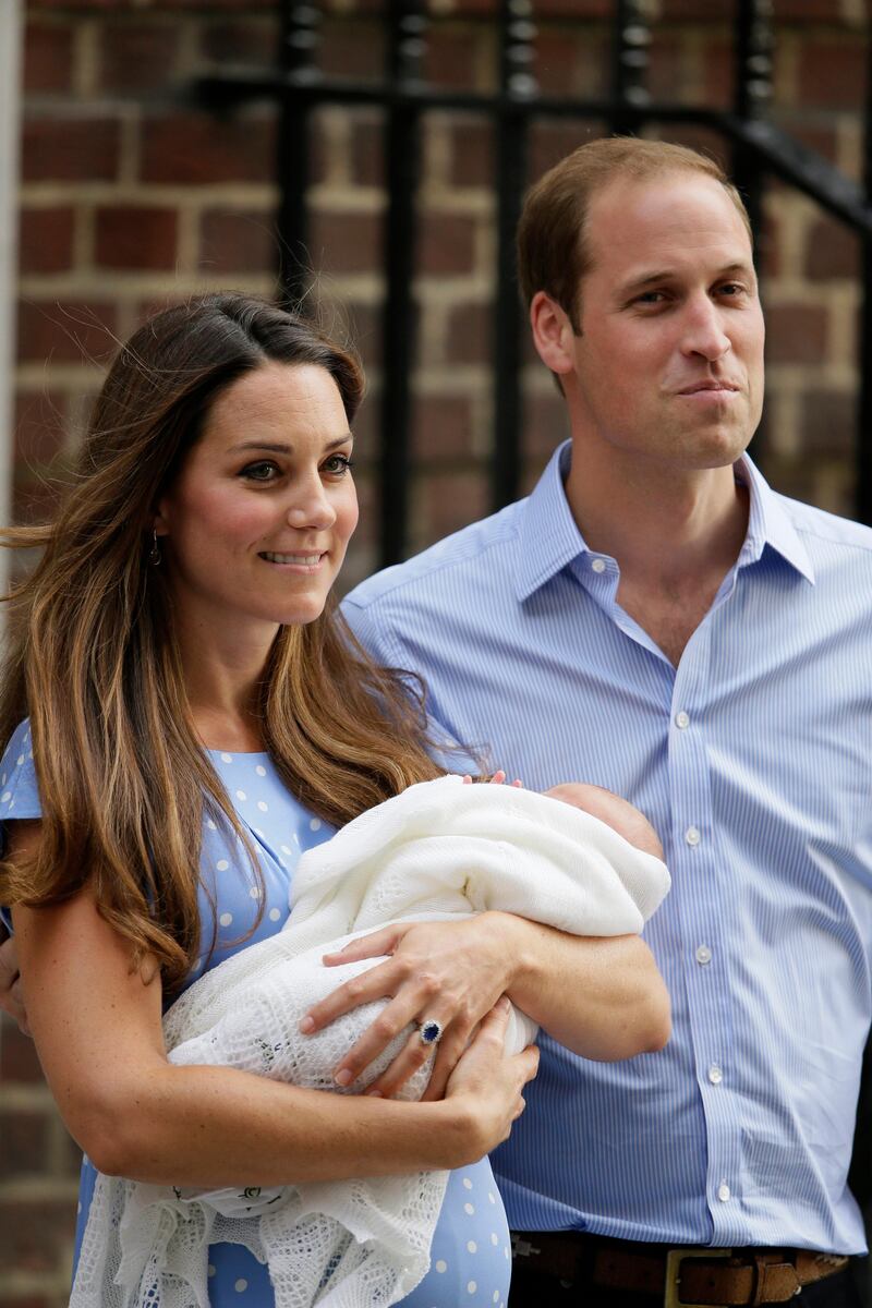 Britain's Prince William, right, and Kate, Duchess of Cambridge hold the Prince of Cambridge, Tuesday July 23, 2013, as they pose for photographers outside St. Mary's Hospital exclusive Lindo Wing in London where the Duchess gave birth on Monday July 22. The Royal couple are expected to head to London’s Kensington Palace from the hospital with their newly born son, the third in line to the British throne. (AP Photo/Alastair Grant) *** Local Caption ***  Britain Royal Baby.JPEG-0468f.jpg