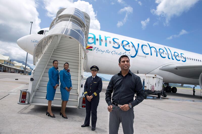 VICTORIA, SEYCHELLES, Mar. 9, 2015:  
(R) Air Seychelles CEO, Manoj Papa, poses for a picture with  some of the company's staff at Victoria airport on Monday, Mar. 9, 2015, in Victoria, the capital of Mahe, the largest of the 115 islands that comprises the Republic of Seychelles, an islands' archipelago located east of the coast of Africa, in the Indian Ocean.  Etihad Airways signed a deal with Seychelles government in January 2012, acquiring 40-percent stake in Air Seychelles. (Silvia Razgova / The National)  (Usage: undated, Section: BIZ, Reporter: Shereen Elgazzar) *** Local Caption ***  SR-150309-airseychelles08.jpg