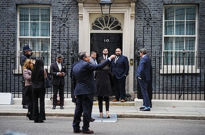 Members of the Muslim community pose in front of 10 Downing Street on April 15. PA