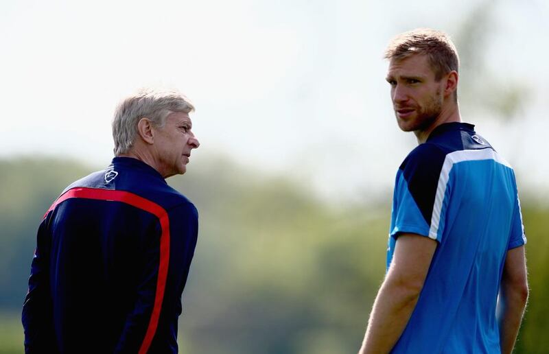 Manager Arsene Wenger of Arsenal talks to Per Mertesacker during Wednesday's training session ahead of the FA Cup final v Hull City on Saturday. Clive Mason / Getty Images / May 14, 2014