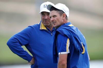 Golf - 2018 Ryder Cup at Le Golf National - Guyancourt, France - September 30, 2018. Team Europe captain Thomas Bjorn with Justin Rose during the singles REUTERS/Charles Platiau