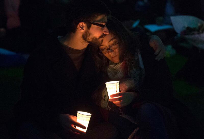 A couple embrace while taking part in a candlelight vigil for bomb victims a day after two explosions hit the Boston Marathon, in Boston, Massachusetts April 16, 2013. The twin blasts on Monday killed three people including an 8-year-old boy and injured 176 others, some of whom were maimed by bombs packed with ball bearings and nails.  REUTERS/Adrees Latif  (UNITED STATES - Tags: CRIME LAW CIVIL UNREST SOCIETY) *** Local Caption ***  AAL120_USA-EXPLOSIO_0417_11.JPG