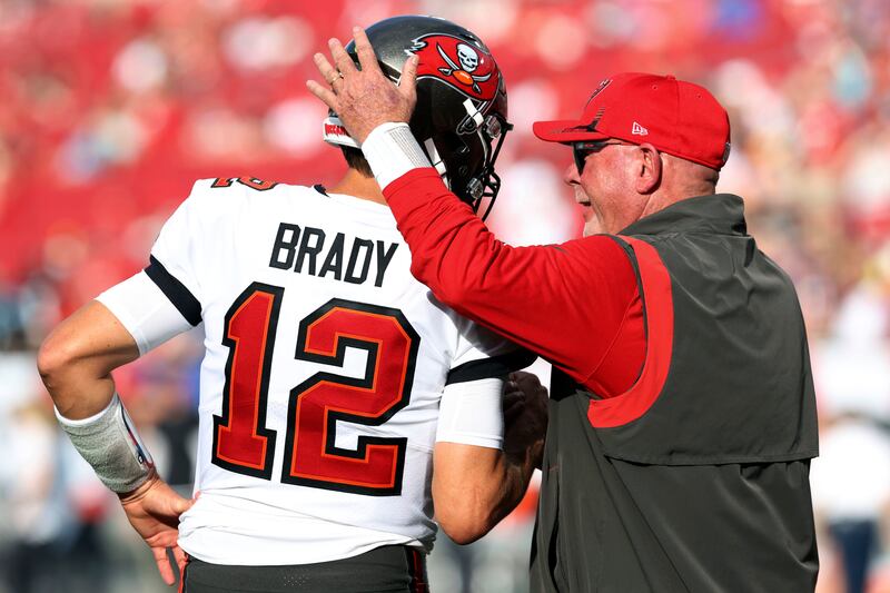 Tampa Bay Buccaneers head coach Bruce Arians talks to quarterback Tom Brady before an NFL game against the Carolina Panthers in 2022. AP