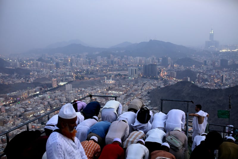 Muslim men attend evening prayer at the top of Mount Al-Noor where the Prophet Mohammed received the first words of the Quran in Mecca, Saudi Arabia. Abir Abdullah / EPA