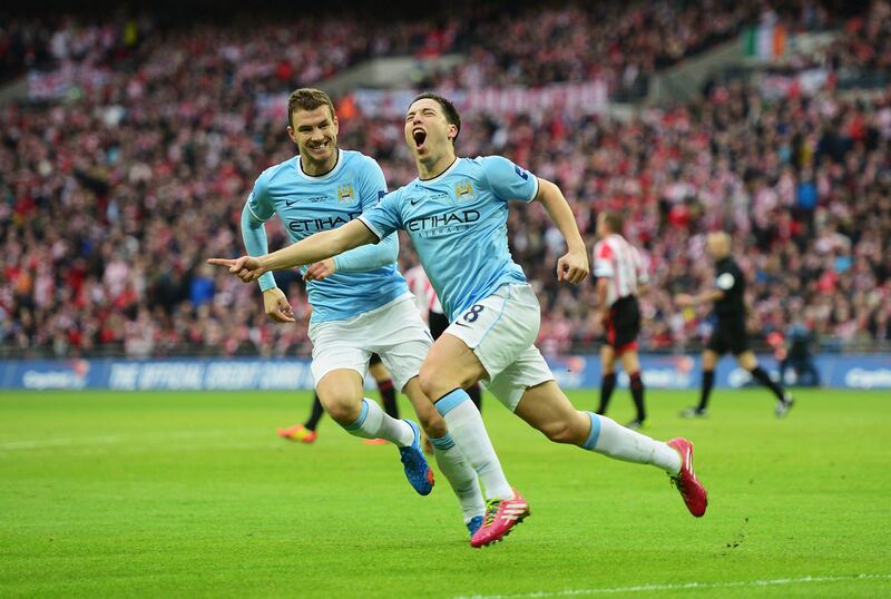 Manchester City's Samir Nasri, front,  Manchester City celebrates scoring his side's second goal in a 2-1 win over Sunderland at Wembley Stadium on March 2, 2014 in the Capital One Cup final. Jamie McDonald / Getty Images