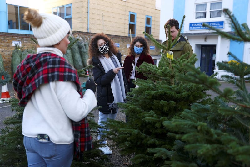 People shop for Christmas trees in the Balham area of London. Reuters