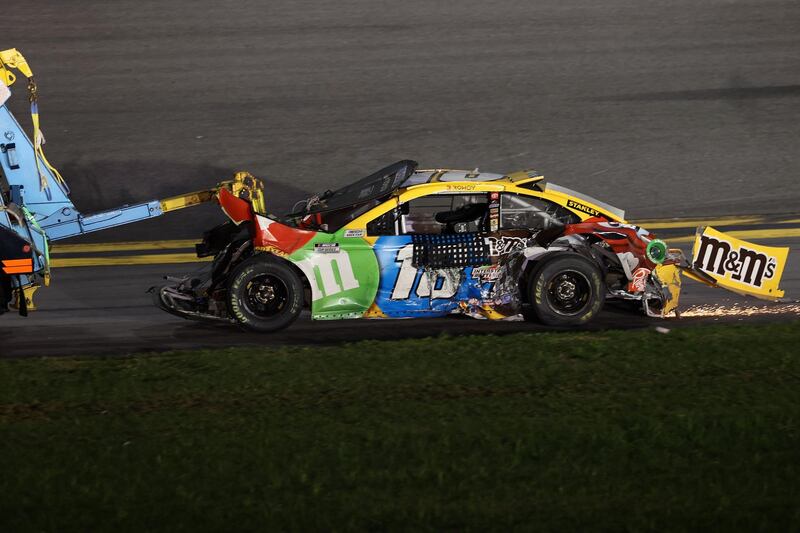Kyle Busch's Toyota, is towed off the track. AFP