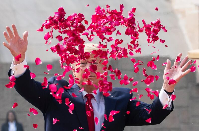 US President Donald Trump offers floral respects at Raj Ghat, the memorial for Mahatma Gandhi, in New Delhi, India. AP