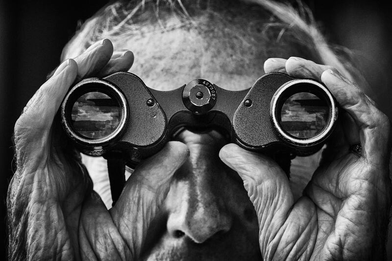 A racegoer watches the action through binoculars at Bath Racecoursein Bath, England. Getty Images