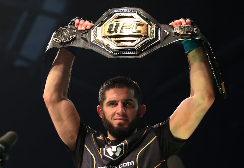 Islam Makhachev celebrates with the belt after winning his fight against Charles Oliveira at UFC 280 in Abu Dhabi on Saturday, October 22, 2022. Reuters