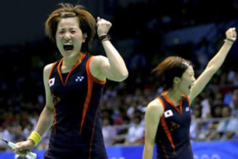 Miyuki Maeda and Satoko Suetsuna celebrate victory.