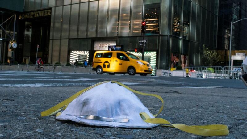 A face mask used to protect from the coronavirus disease is seen on the ground near Trump Tower in New York City, New York, U.S. Reuters