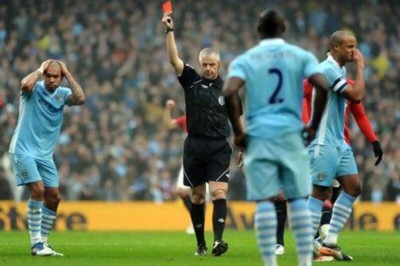 Referee Chris Foy sends off Manchester City’s Vincent Kompany yesterday.