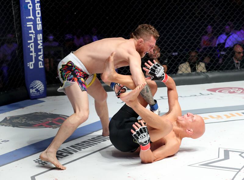 Jesse Arnett throws a punch at Ali Al Qaisi in the featherweight title fight at UAE Warriors 30.