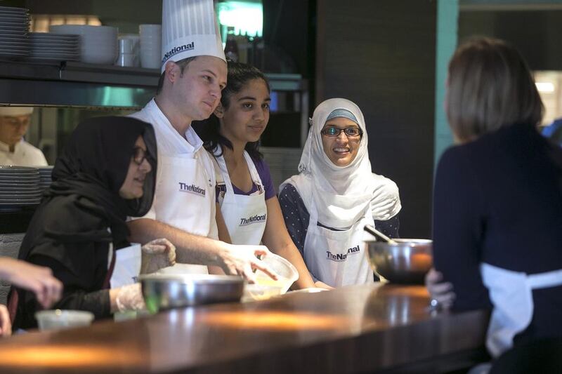 Jordan Annabi, Chef De Cuisine at the Le Royal Meridien hotel in Abu Dhabi, and guests Nabiha Mohamed with daughter, Amina, chat while making desserts. Silvia Razgova / The National