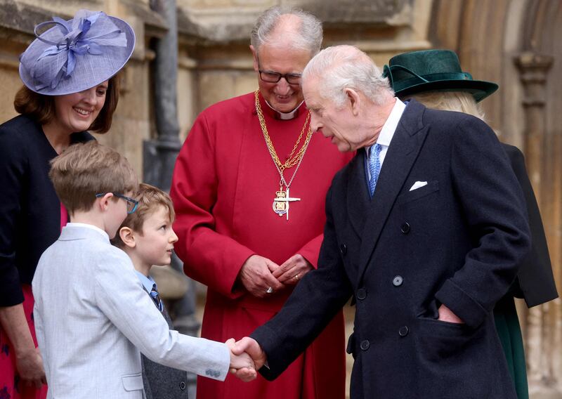 King Charles III greets well-wishers as he leaves St George's Chapel. AFP