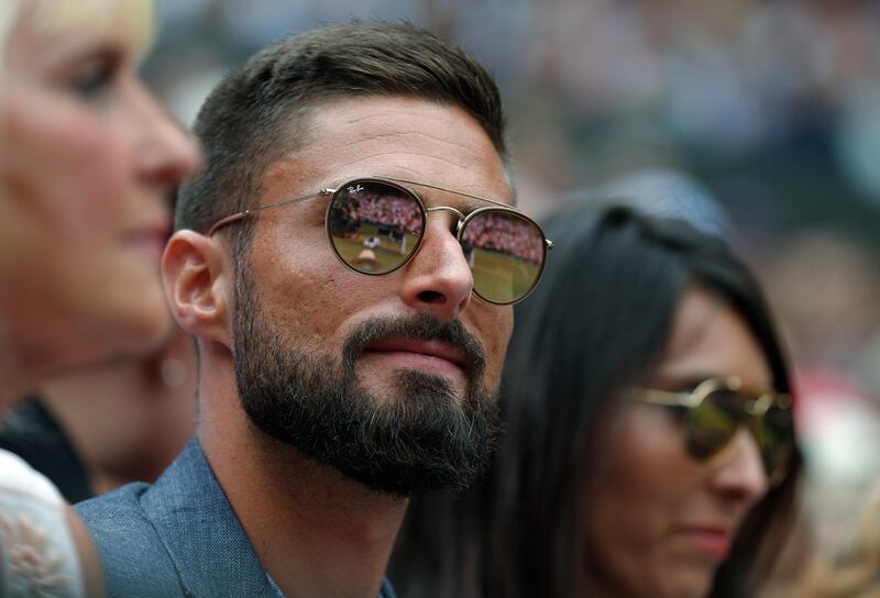 French footballer Olivier Giroud watches Serbia's Novak Djokovic play Switzerland's Roger Federer during the men's singles final match of the Wimbledon Tennis Championships in London, Sunday, July 14, 2019. Adrian Dennis/Pool Photo via AP