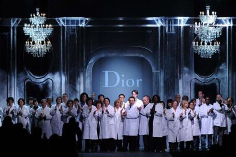 The Christian Dior atelier on the catwalk at the end of the show in Paris. In the absence of a designer, following the sacking of John Galliano, the seamstresses and craftsmen took the final bow at the show.