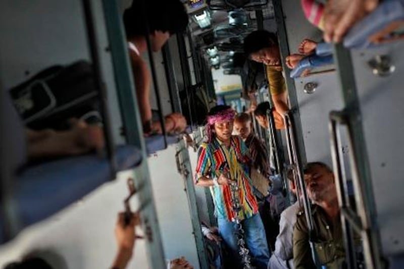 A man sells locks and chains inside a compartment of the Kalka Mail passenger train on the way to Kolkata March 20, 2012. By the end of the day, about 40 people on average will have died somewhere on the network of 64,000 km (39,800 miles) of track. Many will be slum-dwellers and poor villagers who live near the lines and use them as places to wash and as open toilets. Some will have fallen off overcrowded commuter trains. Of the 20 million people who travel daily on the network, many will arrive hours, even a day, behind schedule, having clattered along tracks and been guided by signalling systems  built before India gained independence from Britain in 1947.  To match Insight INDIA-RAILWAYS  REUTERS/Danish Siddiqui (INDIA - Tags: TRANSPORT SOCIETY POLITICS BUSINESS)