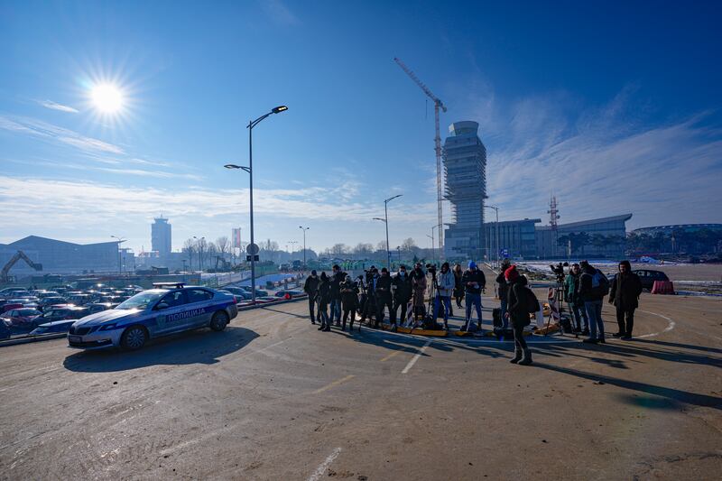 Journalists wait outside the VIP terminal at the Nikola Tesla airport in Belgrade, Serbia. AP