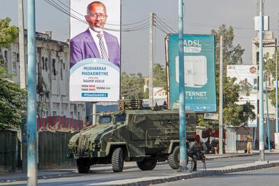 Security forces block a street with an armored personnel carrier during protests against the government and the delay of the country's election in the capital Mogadishu, Somalia Friday, Feb. 19, 2021.  Security forces in Somalia's capital fired on hundreds of people protesting the delay of the country's election on Friday as at least one explosion was reported at the international airport and armored personnel carriers blocked major streets. (AP Photo)