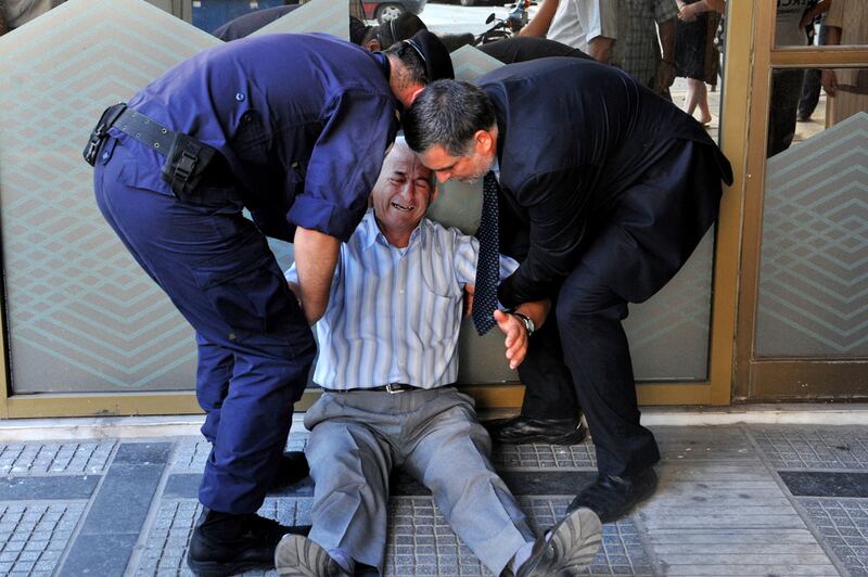 “I see my fellow citizens begging for a few cents to buy bread. I see more and more suicides. I am a sensitive person. I cannot stand to see my country in this situation,” says 77-year-old Giorgos Chatzifotiadis. Sakis Mitrolidis/AFP Photo

