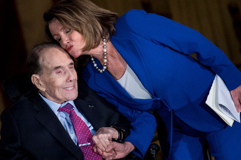 Dole with Democratic House minority leader Nancy Pelosi during his Congressional Gold Medal ceremony on Capitol Hill in Washington, DC, in January 2018. AFP